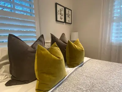 a group of pillows on a bed in a bedroom at Clearbrooke Gem- Bright Private Bedroom close to YYZ in Toronto