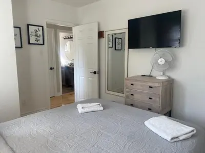 a bedroom with a bed with a television on the wall at Clearbrooke Gem- Bright Private Bedroom close to YYZ in Toronto