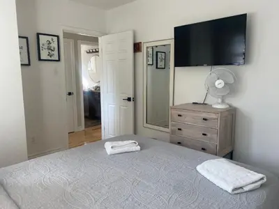 a bedroom with a bed with a television on the wall at Clearbrooke Gem- Bright Private Bedroom close to YYZ in Toronto