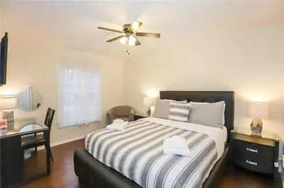 a bedroom with a bed with a ceiling fan at Dorchester Cottage Licence 044-2022 in Niagara on the Lake