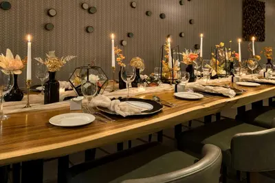 a long wooden table with plates and wine glasses at Element Toronto Airport in Mississauga
