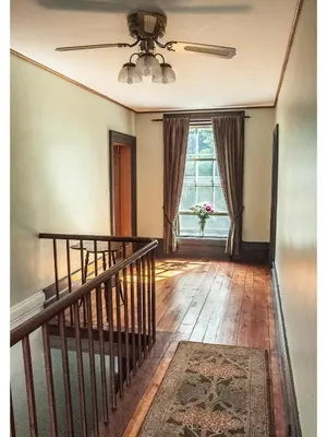 an empty room with a staircase and a window at Culverdene House in Simcoe