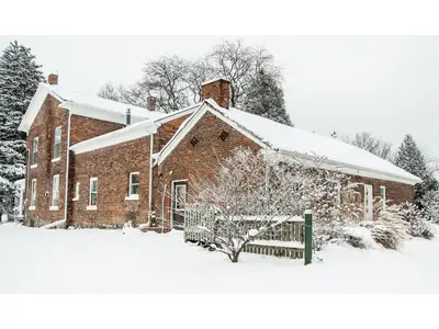 a red brick building with snow on it at Culverdene House in Simcoe