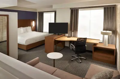 a hotel room with a bed and a desk with a computer at Residence Inn by Marriott Toronto Mississauga Southwest in Mississauga