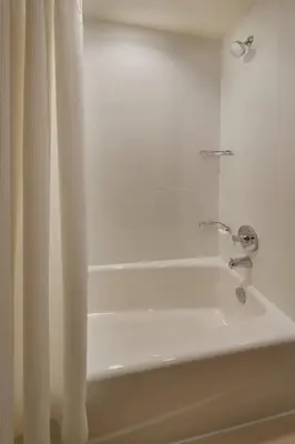 a white bath tub with a shower curtain at Residence Inn by Marriott Toronto Mississauga Southwest in Mississauga