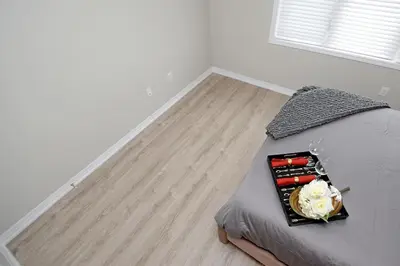 a bedroom with a bed with a tray with flowers on it at Royal Stays Townhome Collection - 3 Bedroom Townhome in Oakville in Oakville