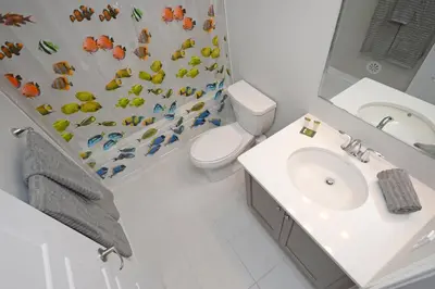 a bathroom with a toilet and a shower curtain at Royal Stays Townhome Collection - 3 Bedroom Townhome in Oakville in Oakville