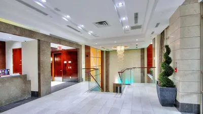 a lobby with a staircase in a building at PlanURstay - Luxury Suites Mississauga Downtown in Mississauga