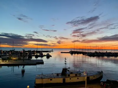 a group of boats docked in a marina at sunset at Paradise Inn On the Beach in Port Elgin