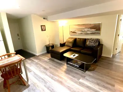 a living room with a couch and a coffee table at Metropolitan Suite in Niagara Falls