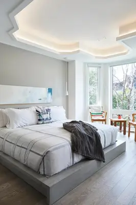 a white bedroom with a large bed in a room at Elegant Downtown Home in Toronto
