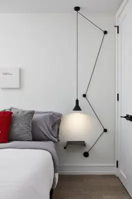 a bedroom with a bed and a light hanging from the wall at Elegant Downtown Home in Toronto