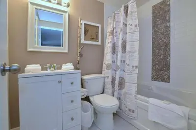 a white bathroom with a toilet and a sink at #Ski-in/Ski-out Cozy Studio at North Creek Resort in Blue Mountains