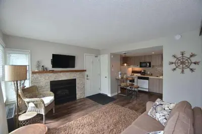 a living room with a couch and a fireplace at #Ski-in/Ski-out Cozy Studio at North Creek Resort in Blue Mountains
