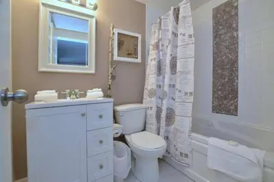 a white bathroom with a toilet and a sink at #Ski-in/Ski-out Cozy Studio at North Creek Resort in Blue Mountains