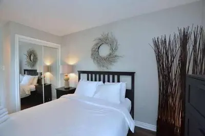 a bedroom with a large white bed and a mirror at #Ski-in/Ski-out Cozy Studio at North Creek Resort in Blue Mountains