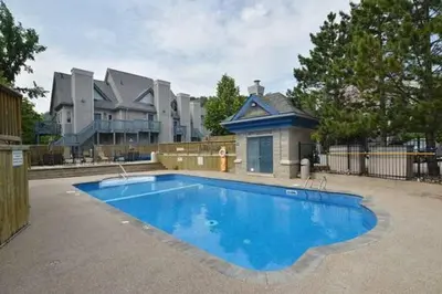 a large blue swimming pool in front of a building at #Ski-in/Ski-out Cozy Studio at North Creek Resort in Blue Mountains