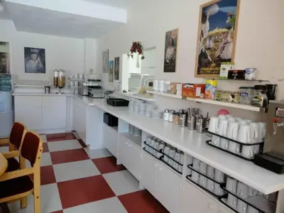 a kitchen with white counters and a checkered floor at Shakespeare Inn in Shakespeare