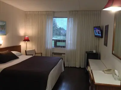 a hotel room with a bed and a window at Shakespeare Inn in Shakespeare