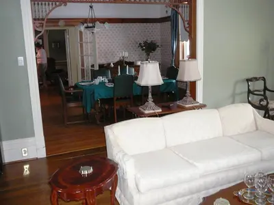 a living room with a white couch and a table at Gables Bed & Breakfast in Stayner