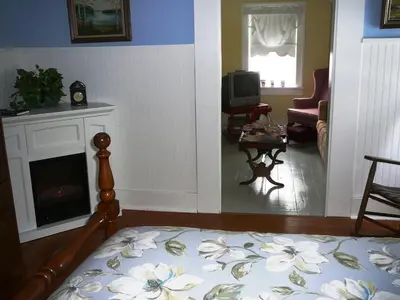 a living room with a bed and a fireplace at Gables Bed & Breakfast in Stayner