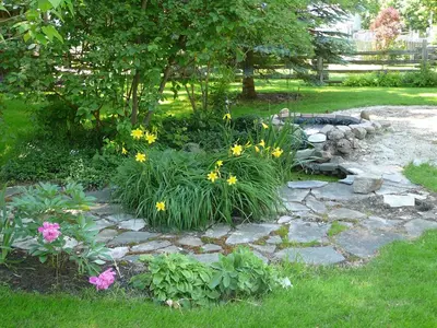 a garden with flowers and a stone path at Gables Bed & Breakfast in Stayner