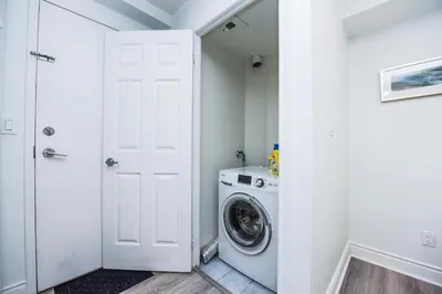 a white laundry room with a washer and dryer at PlanURstay - Luxury 1BR Condo with City View in Mississauga