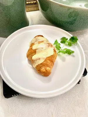 a plate with a piece of bread with cheese on it at Plantation House Bed & Breakfast in Port Hope