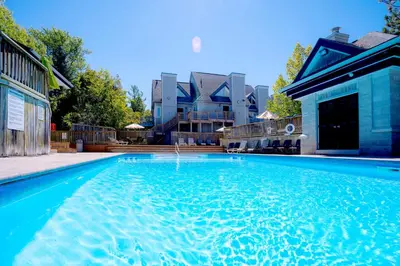 a swimming pool in front of a building at Gorgeous Loft in the Heart of Blue Mountain in Blue Mountains