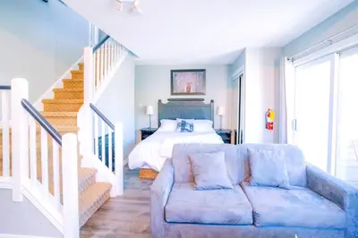 a living room with a couch and a bed at Gorgeous Loft in the Heart of Blue Mountain in Blue Mountains