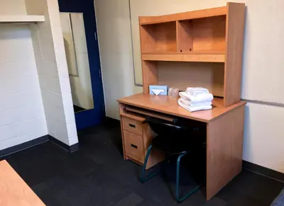an office with a wooden desk and a chair at Toronto Metropolitan University- Pitman Hall Residence in Toronto