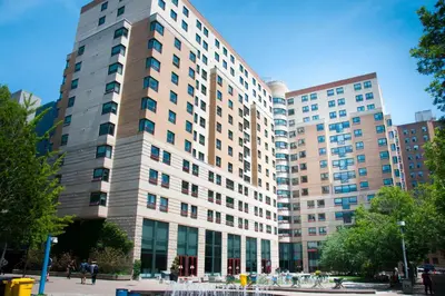 a large building with many windows in a city at Toronto Metropolitan University- Pitman Hall Residence in Toronto