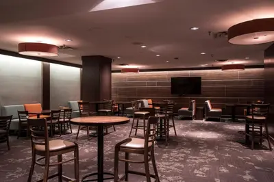a dining room with tables and chairs and a flat screen tv at Toronto Metropolitan University-International Living Learning Residence in Toronto