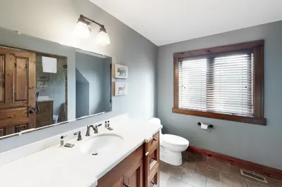 a bathroom with a sink and a toilet and a mirror at Lucille 109 in Blue Mountains