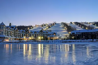 a resort in the snow next to a body of water at Cachet Crossing in Blue Mountains