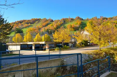 a building on a hill with fall foliage at Condo 206 at North Creek Resort in Blue Mountains