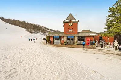 a building with a clock tower on a ski slope at Condo 206 at North Creek Resort in Blue Mountains