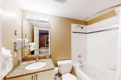 a bathroom with a sink and a toilet and a tub at Condo 503 at North Creek Resort in Blue Mountains