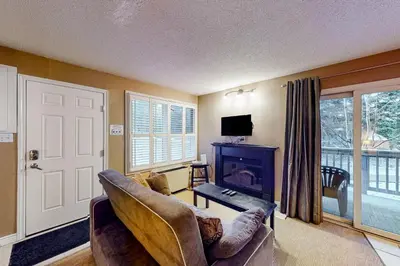 a living room with a couch and a fireplace at Condo 503 at North Creek Resort in Blue Mountains