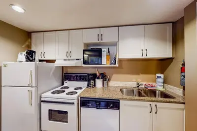 a kitchen with white appliances and a white refrigerator at Condo 503 at North Creek Resort in Blue Mountains
