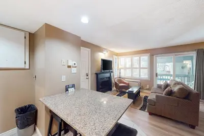 a kitchen and living room with a table and a couch at Condo 904 at North Creek Resort in Blue Mountains