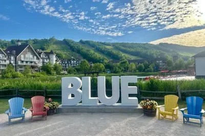 a blue sign with colorful chairs in front of it at Condo 904 at North Creek Resort in Blue Mountains