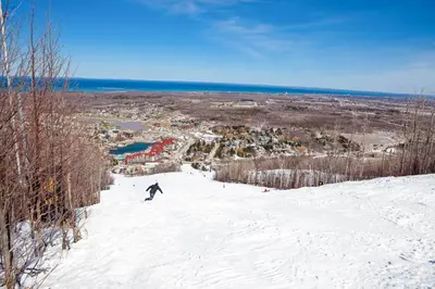 a person riding a snowboard down a snow covered slope at Condo 310 at North Creek Resort in Blue Mountains