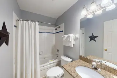 a bathroom with a sink and a toilet and a tub at Condo 310 at North Creek Resort in Blue Mountains