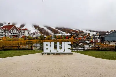 a large blue sign sitting on top of a field at Condo 310 at North Creek Resort in Blue Mountains