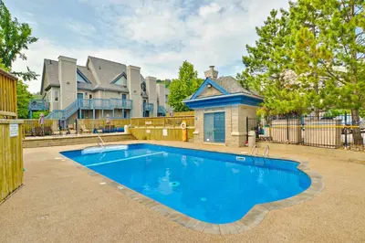 a large blue swimming pool in front of a house at Condo 413 at North Creek Resort by Vacasa in Blue Mountains