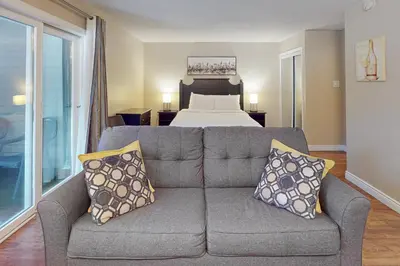 a living room with a couch and a bed at Condo 704 at North Creek Resort in Blue Mountains