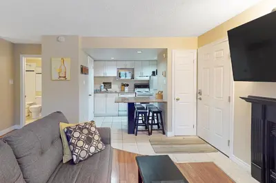 a living room with a couch and a kitchen at Condo 704 at North Creek Resort in Blue Mountains