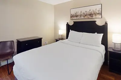 a bedroom with a large white bed and two lamps at Condo 704 at North Creek Resort in Blue Mountains