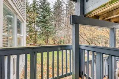 a screened porch with a blue railing on a house at Condo 704 at North Creek Resort in Blue Mountains